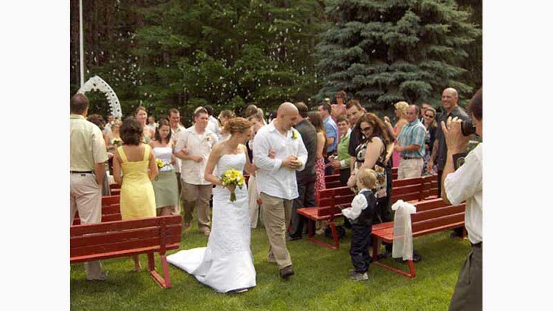 From wedding 3, DJ Niagara, From wedding 3. Bride & groom walking down isle after outdoor ceremony, lots of bubbles overhead, both looking and smiling at a little boy standing close. Taken in Niagara Ontario